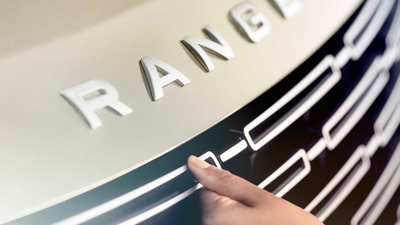 Range Rover front dumber with female hand