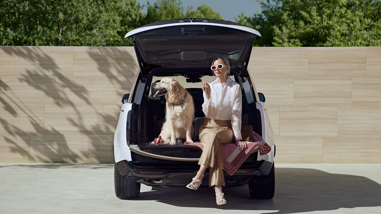 Women and dog sat in boot of Range Rover, Wimbledon content