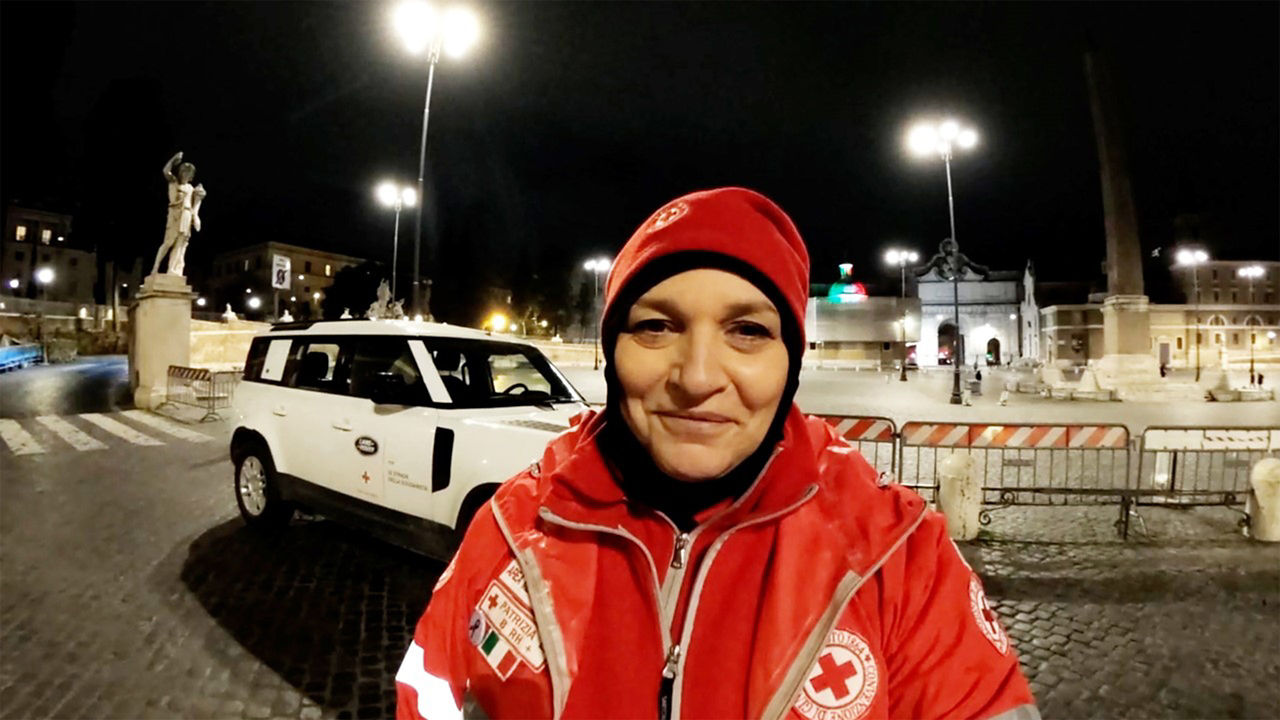 Italian Red Cross team member stood in front of Defender