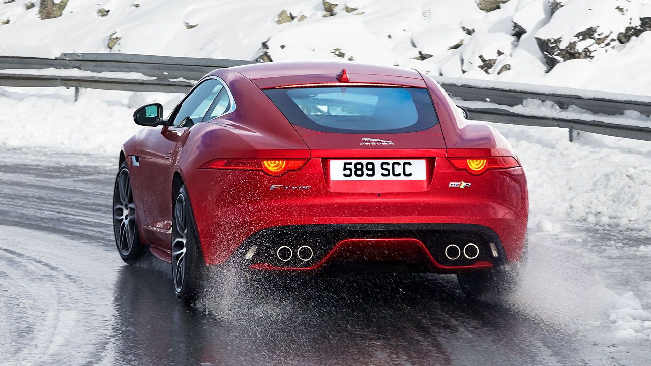 Jaguar F-TYPE  running on a road covered by snow in iceland