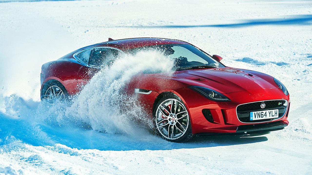 Jaguar F-TYPE  running on a road covered by snow in iceland