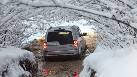 Land Rover driving through mud and snow