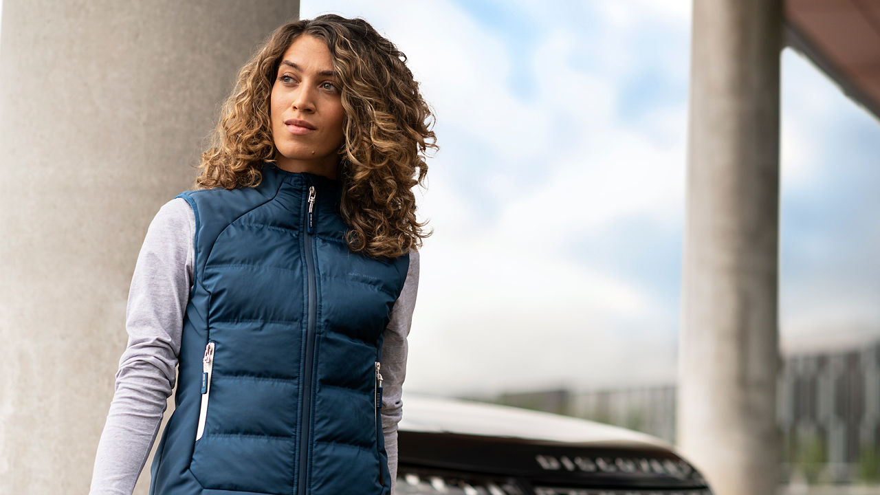 Female model standing beside the car wearing Quilted Gilet Jacket