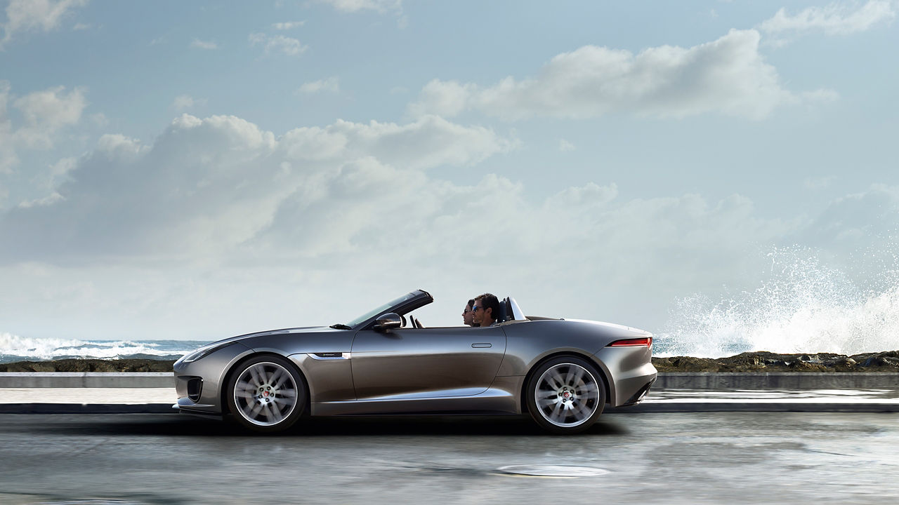 Jaguar F-TYPE  running on beach side road