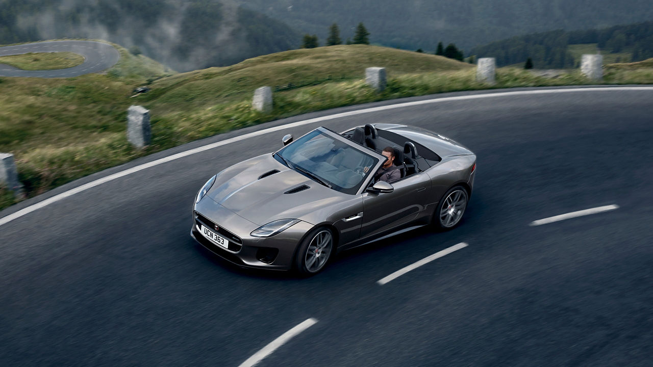 Jaguar F-TYPE  running on hill road, top view