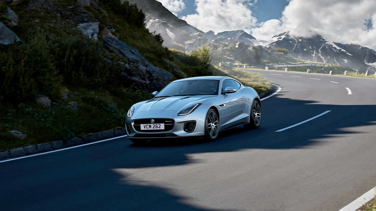 Jaguar F-TYPE  running on hill road, top view