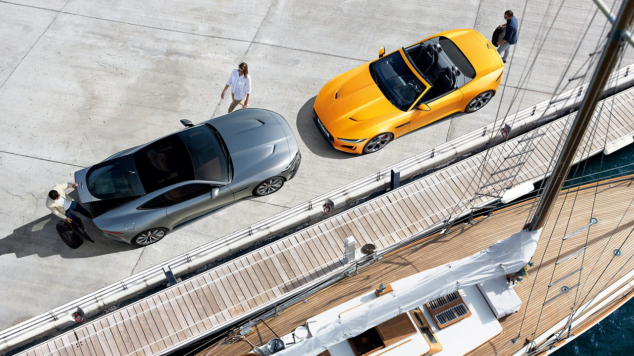 Man is loading luggage in Jaguar F-Type