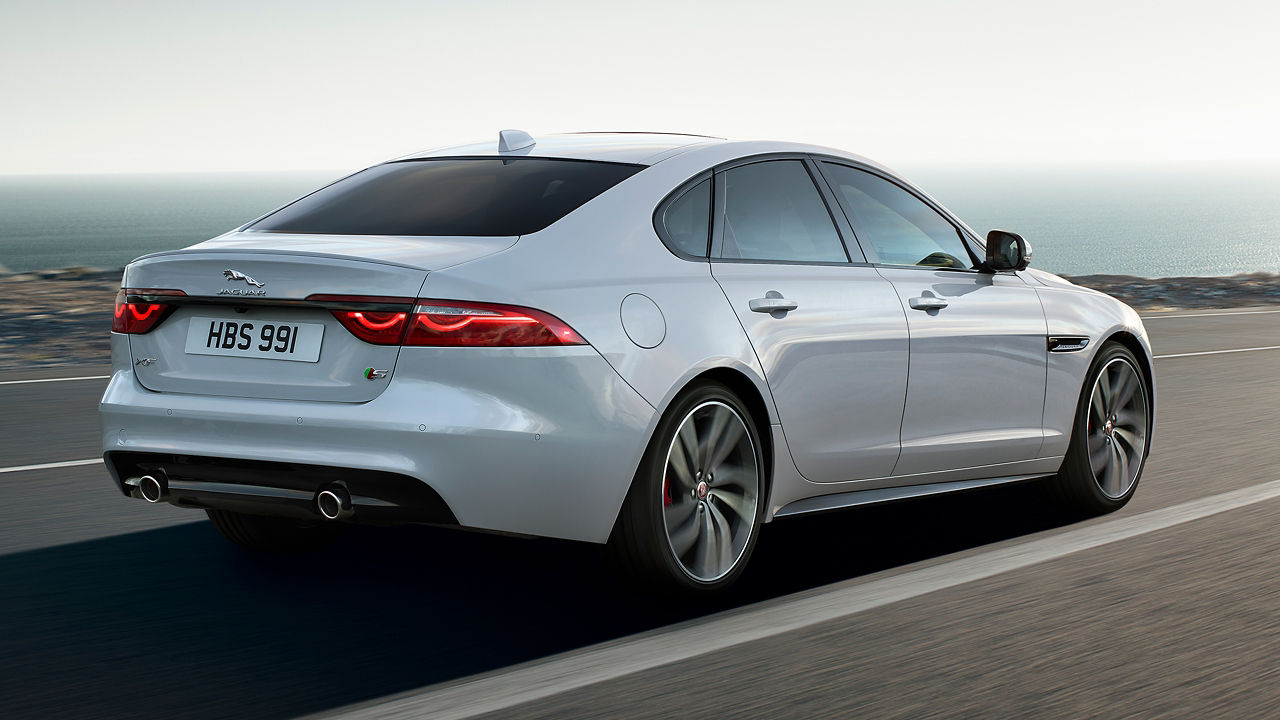 Jaguar XF running on the hilly terrain  road