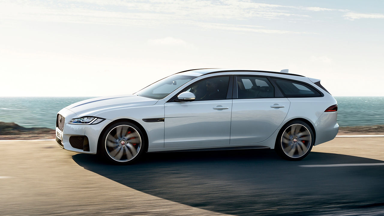 Jaguar XF running on the sea side road