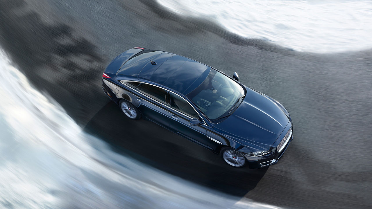 Jaguar XJ running on the road, top view