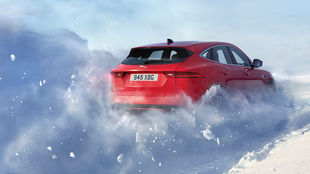 Jaguar E-PACE passes through a snowdrift and snowy land road