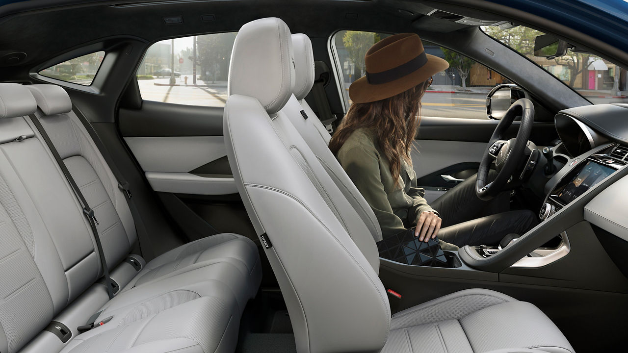 A woman looking outside from the E-PACE car