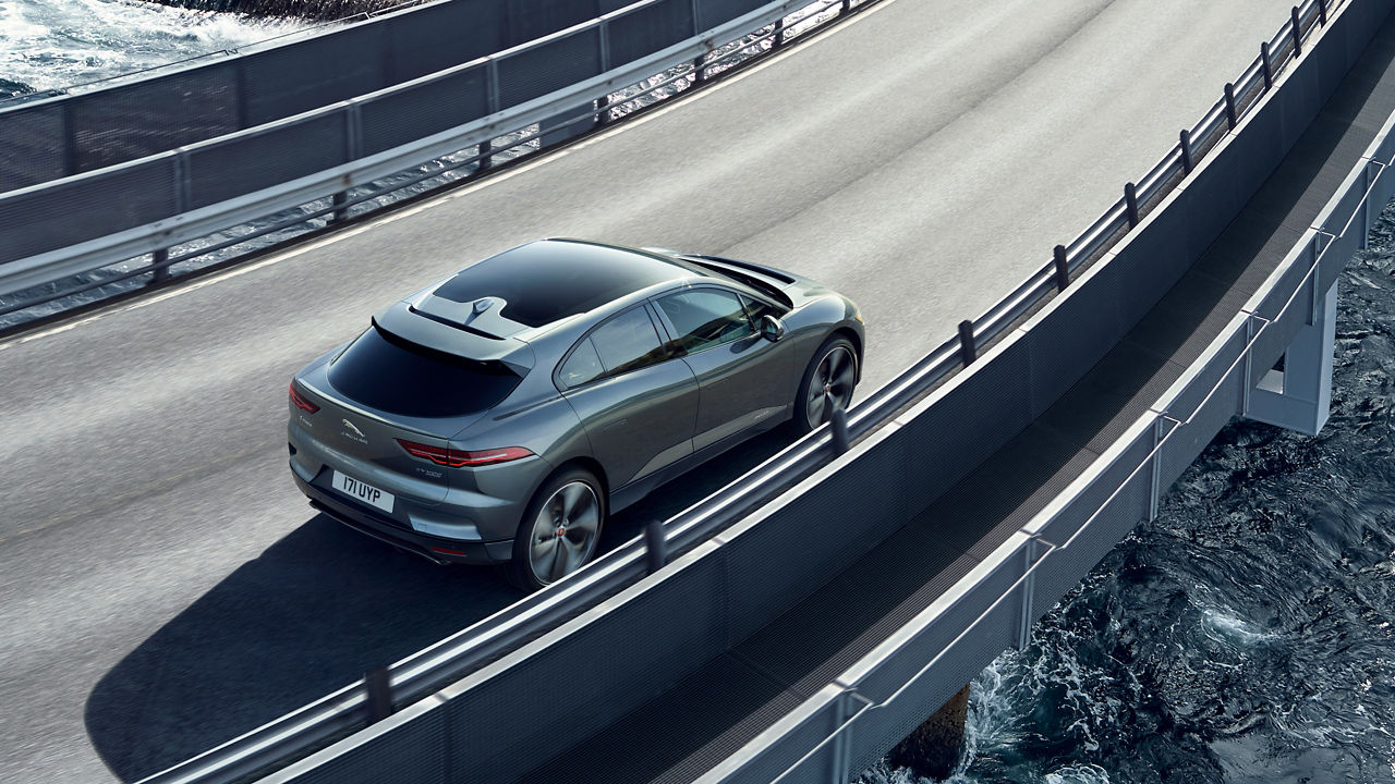 Jaguar I-PACE running on bridge which is on river
