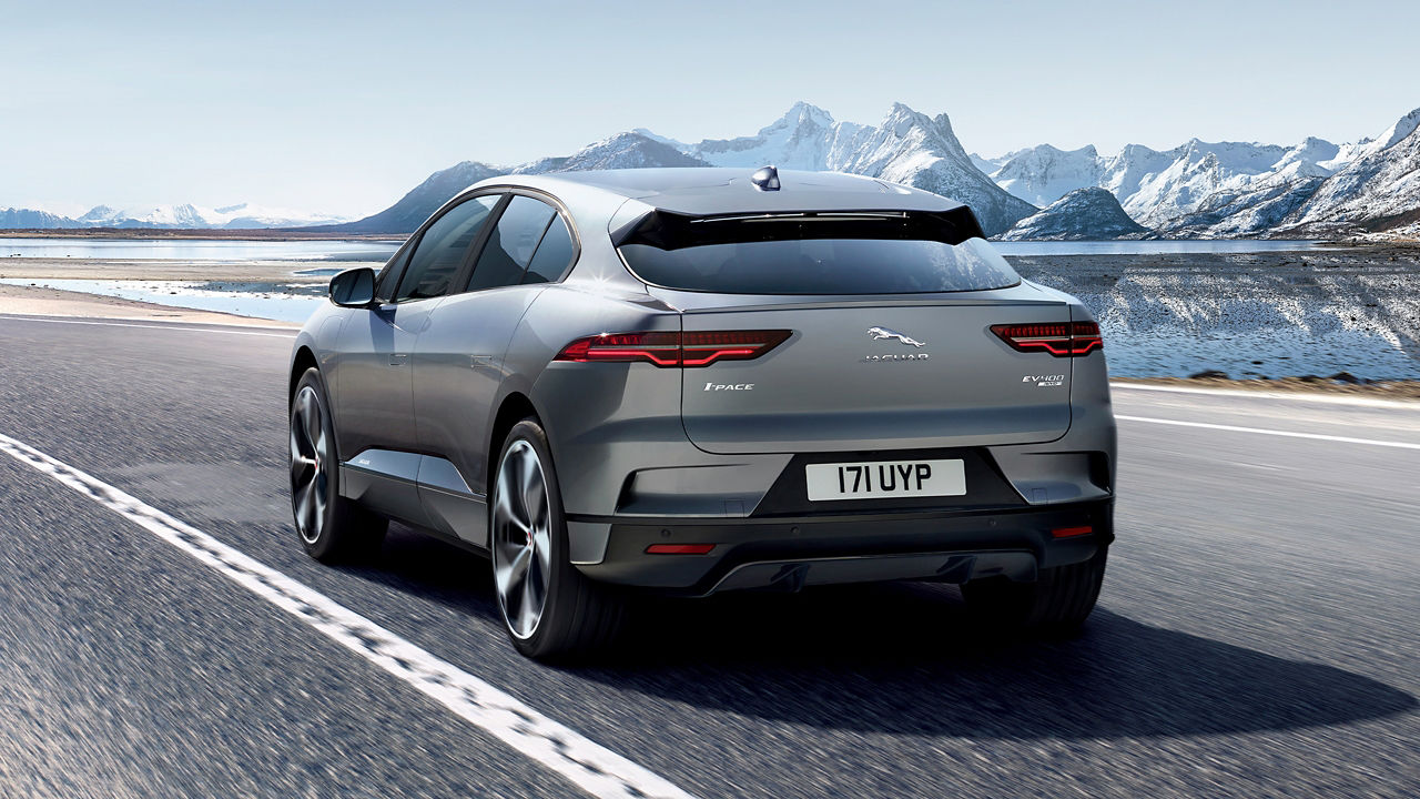 Jaguar I PACE running on road beside river and Ice mountains