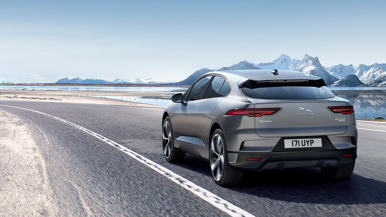 Jaguar I-Pace running on the road and with ice mountain background 