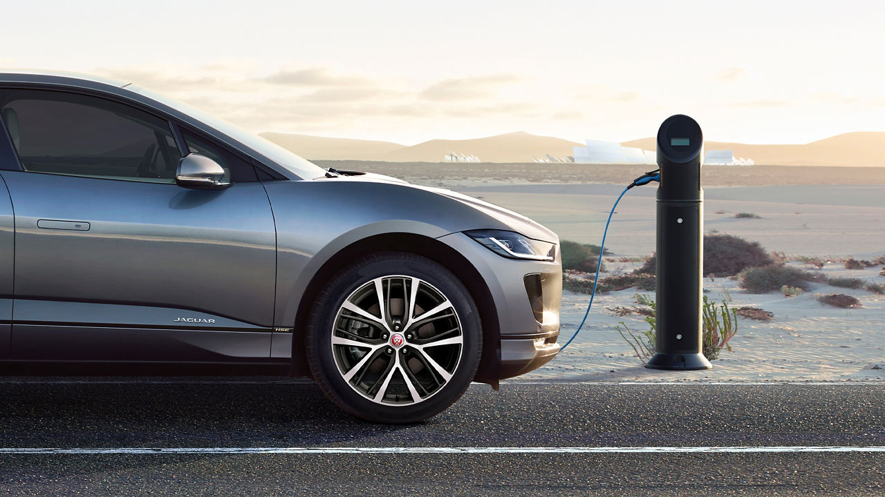 Jaguar I-Pace parked for charging  in middle of  desert road