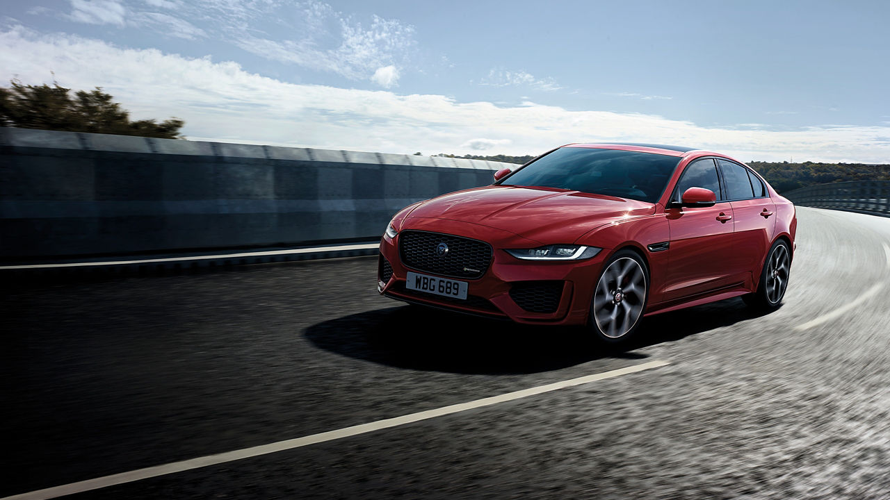 Jaguar XE running on highway bridge