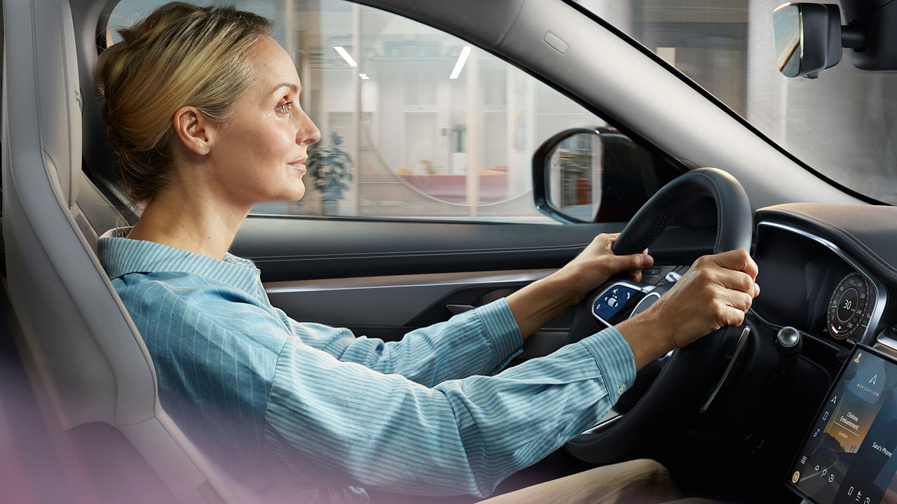 A women driving Jaguar F-Pace 