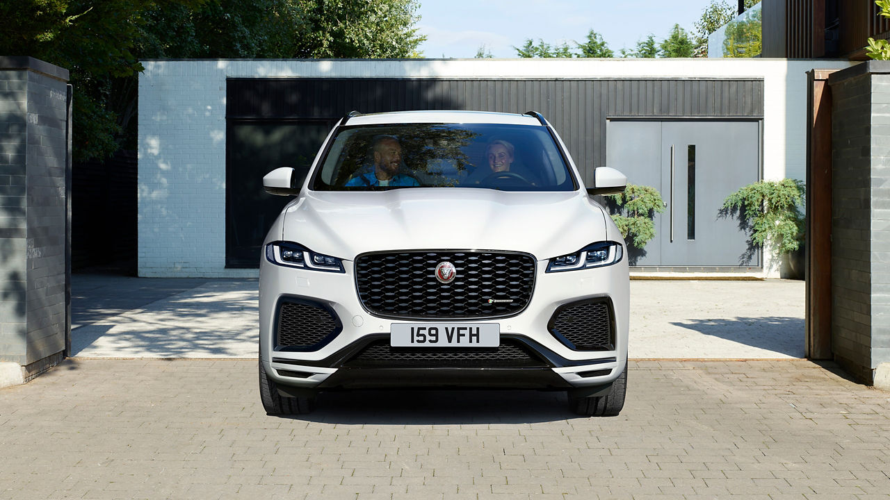 Couple enjoying ride in Jaguar F-Pace 