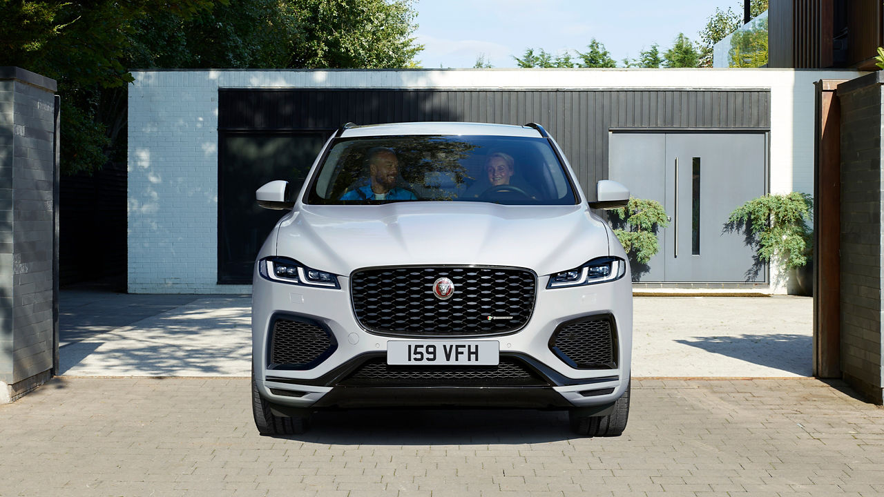 Couple enjoying ride in Jaguar F-Pace 