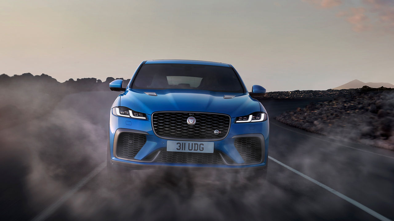 Jaguar car running on asphalt road, Front view