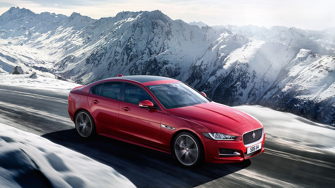 Jaguar XE running on ice mountain hill road