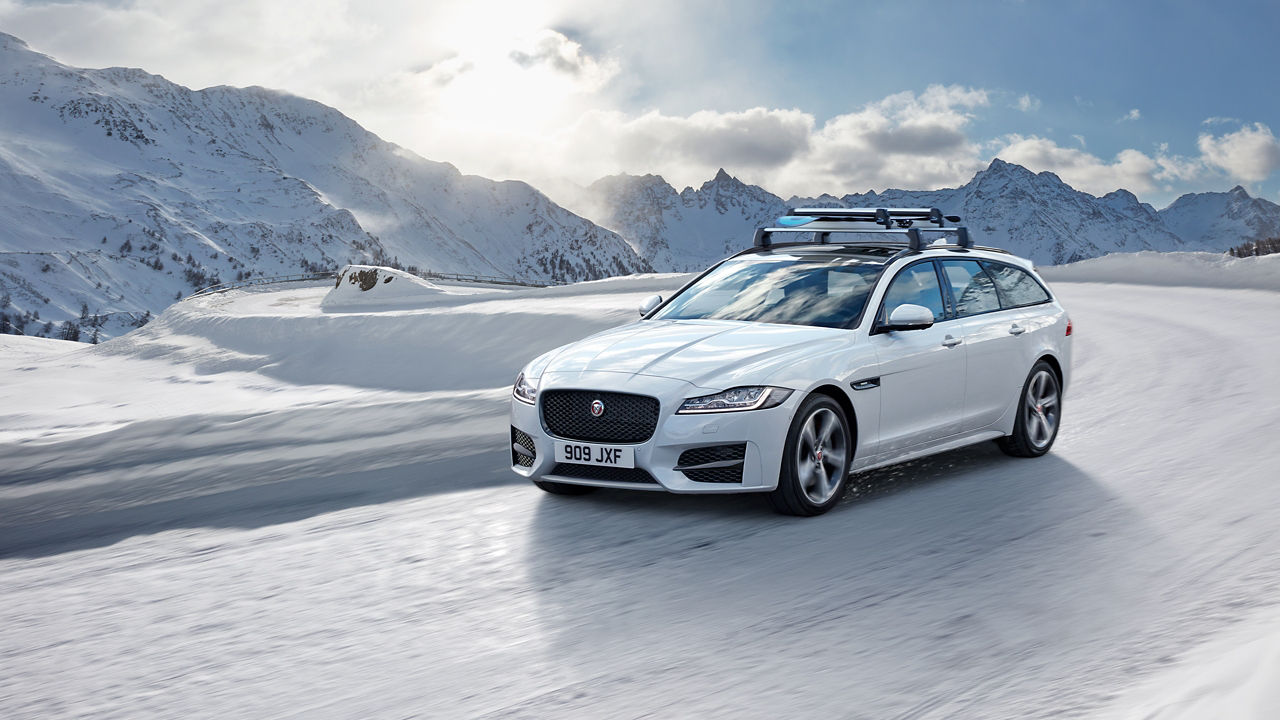 Jaguar XF Sportbrake moving on a  Snow Hilly Road