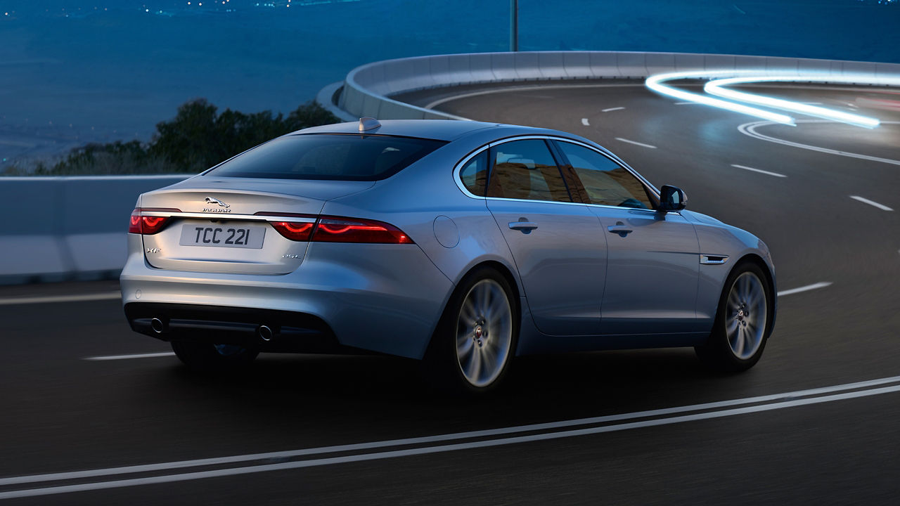 Jaguar XF running on the hilly seaside road