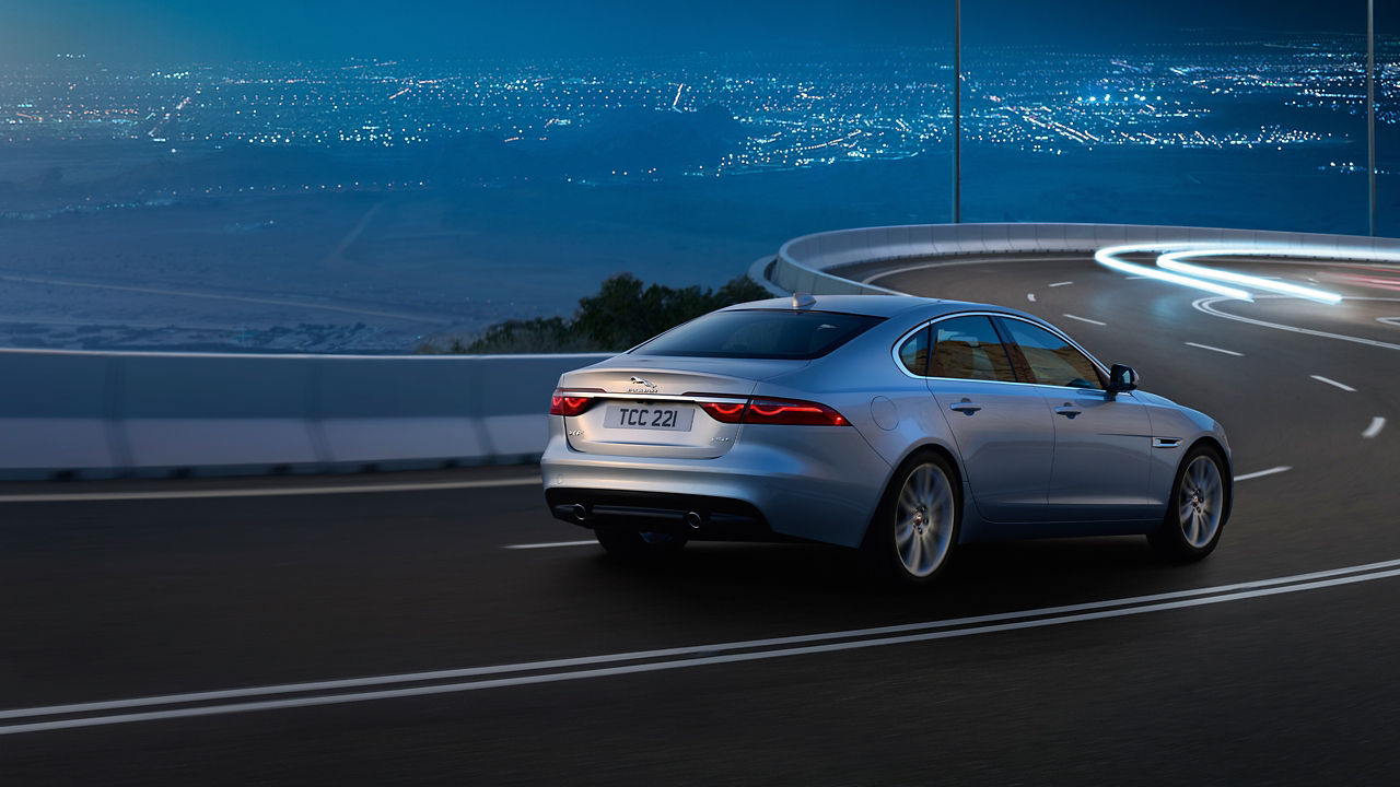 Jaguar XF running on the hilly seaside road