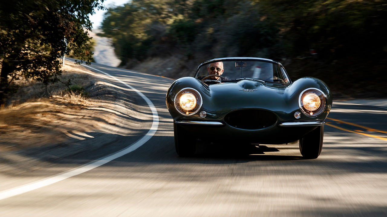 Jaguar XKSS car running on the road, front view