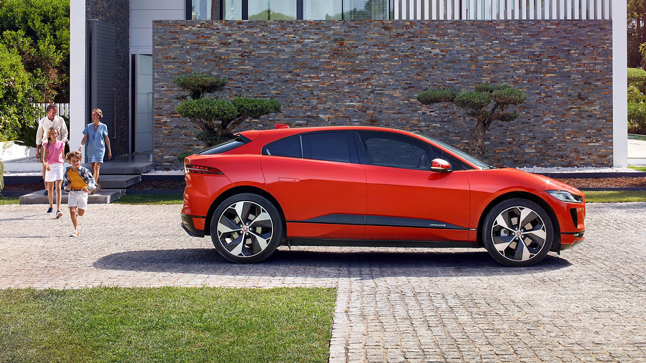 Family outing in Jaguar I pace which is parked near house