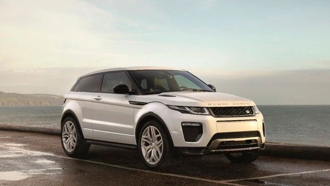 White range rover at a shore